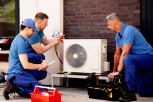3 HVAC employees working on a unit