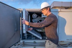 Man inspecting filter on HVAC system