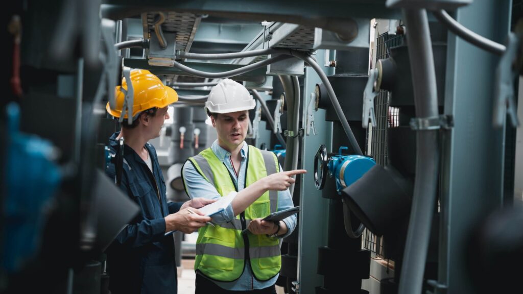 two men inspecting HVAC system