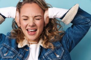 woman holding her hands over her ears