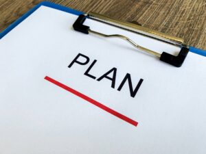 clipboard with the word plan on it